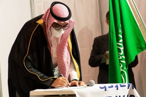 大会フラッグにサインをするサウジアラビアeスポーツ連盟のターキ・アルファザンCEO