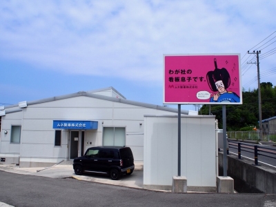 ひとおしくんは本社近くの道路脇の広告にも描かれている